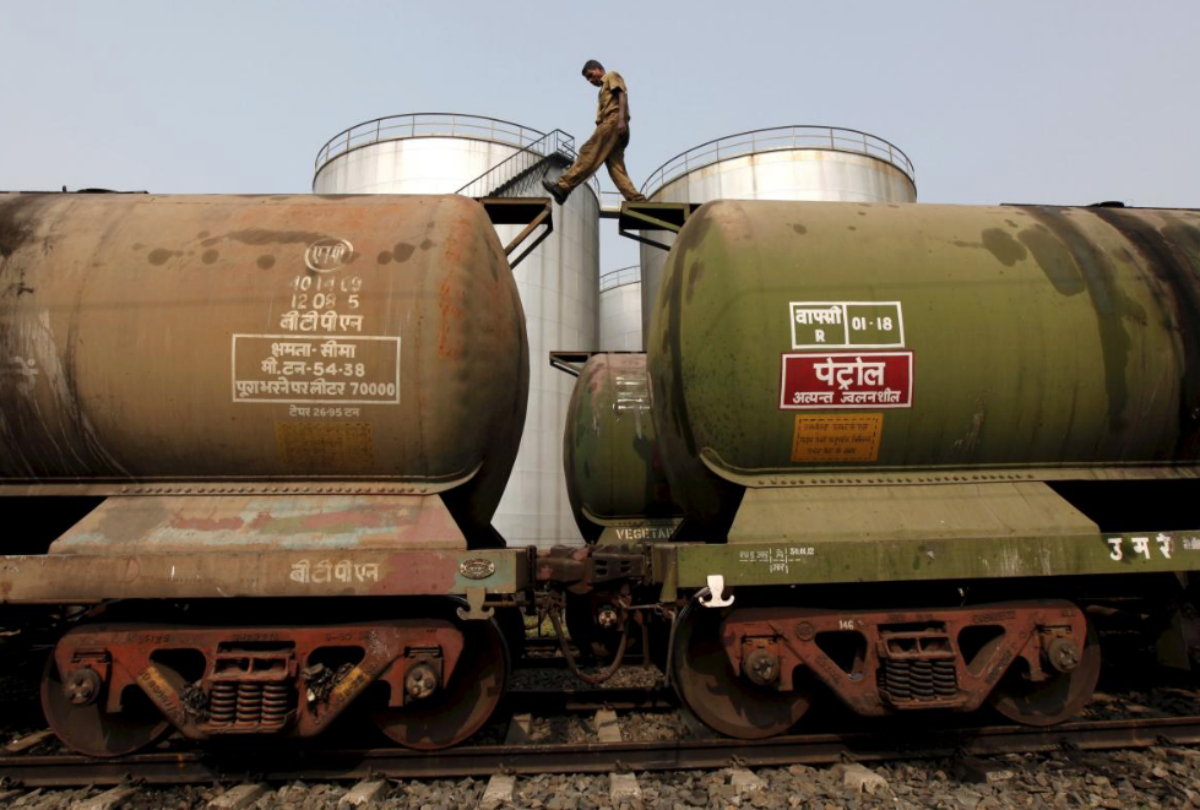 FILE PHOTO: A worker walks atop a tanker wagon to check the freight level at an oil terminal on the outskirts of Kolkata, India November 27, 2013. REUTERS/Rupak De Chowdhuri/File Photo