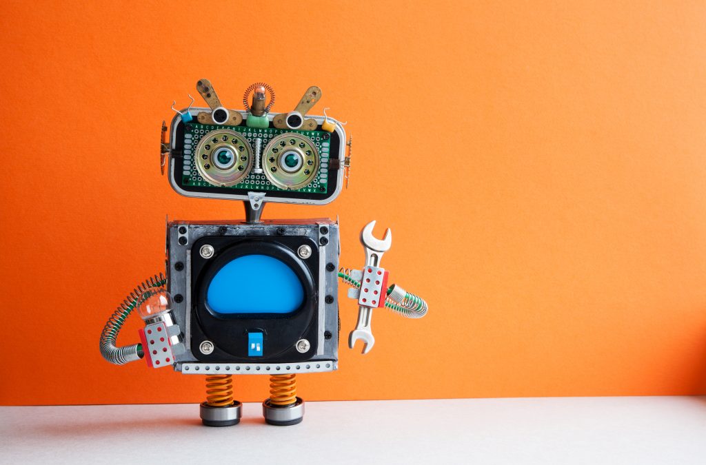 Robot handyman with hand wrench light bulb. Fixing maintenance concept. Creative design mechanic toy character. Orange wall, light floor background. Copy space
