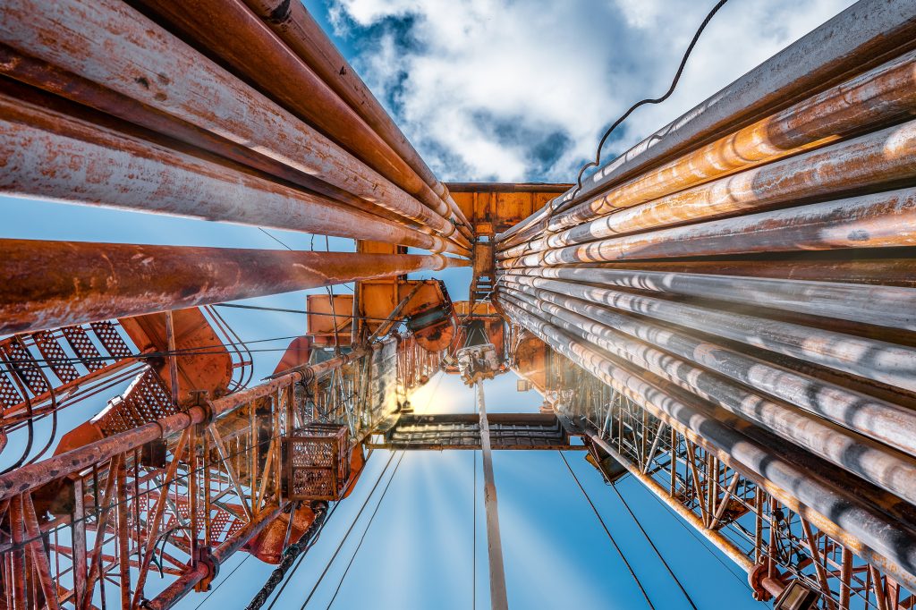 oil and gas drilling rig onshore dessert with dramatic cloudscape. oil drilling rig operation on the oil platform in oil and gas industry.