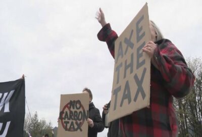 axe the tax holding sign 1200x810
