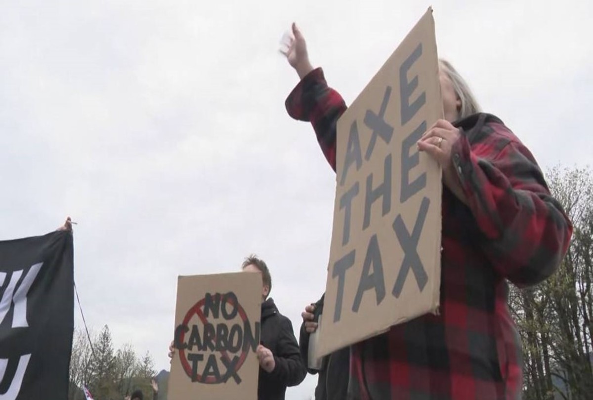 axe the tax holding sign 1200x810