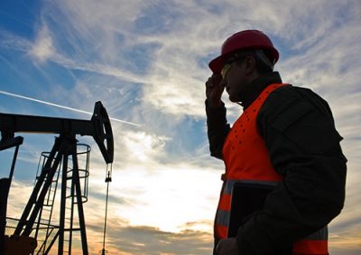 oilfield worker by pumpjack 1200x810