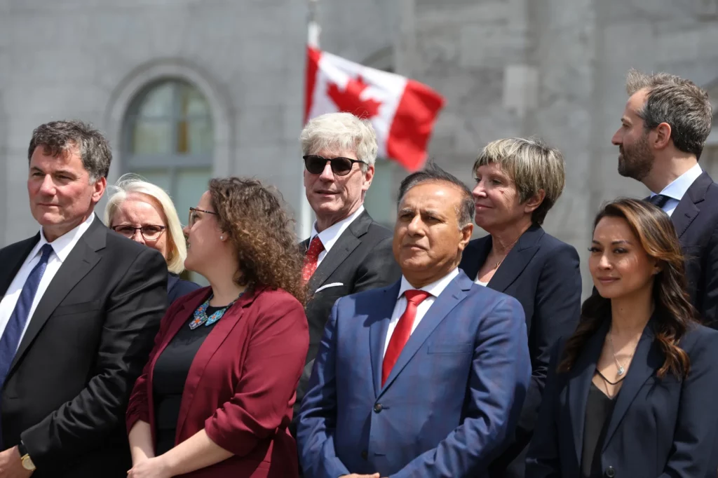 tim hodgson, top row center, is wearing shades because canada’s economic future is so bright