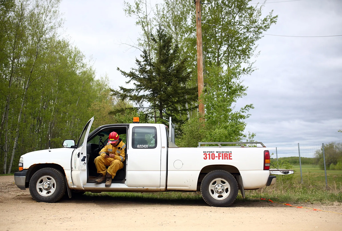 alberta forestry ranger sits in a truck outside the lac la biche wildfire forest fire 1200x810